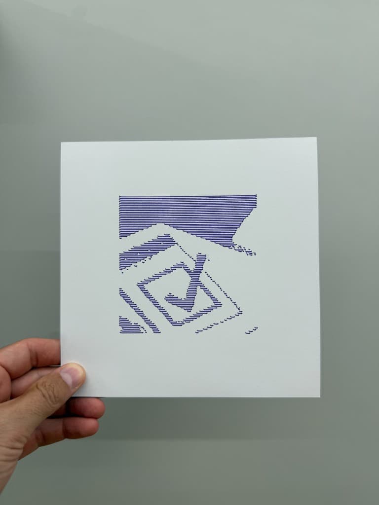Hand holding pen-plotted blue horizontal-line checkmark stencil on white cardstock